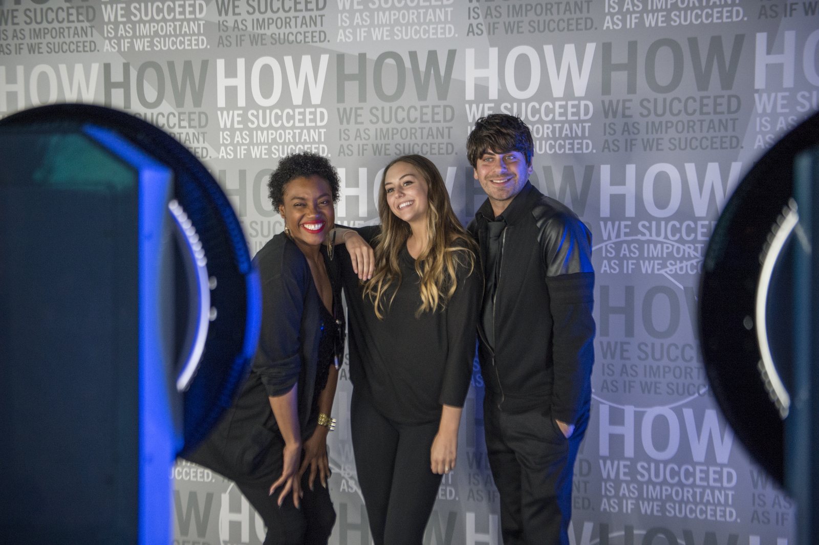 Guests posing between two photo booths at the Baird 100-year celebration